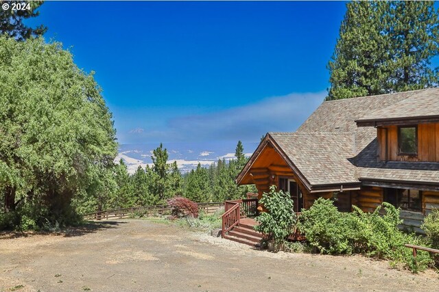 rear view of house featuring a wooden deck