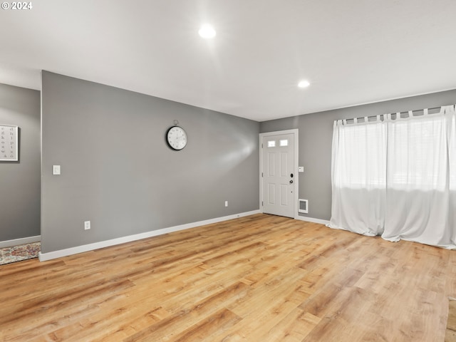 foyer entrance with light hardwood / wood-style floors