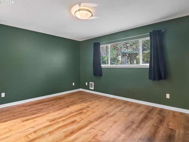 empty room with wood-type flooring