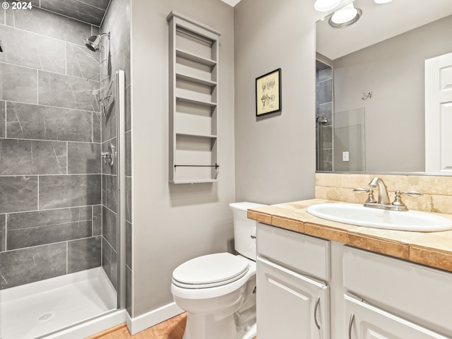 bathroom featuring vanity, wood-type flooring, an enclosed shower, and toilet