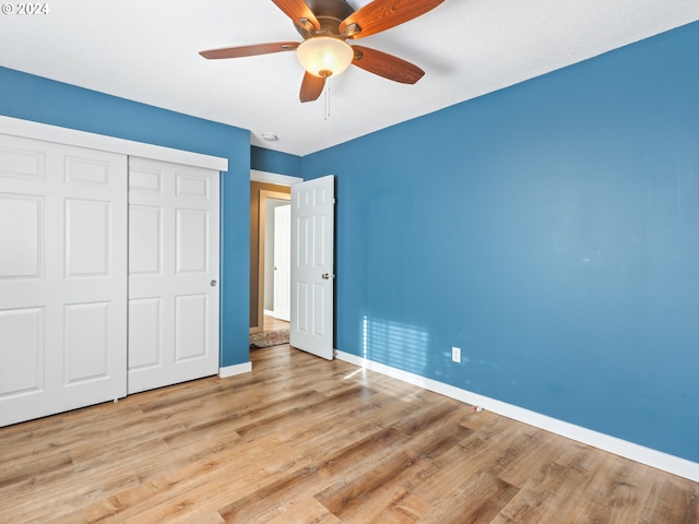 unfurnished bedroom with ceiling fan, light hardwood / wood-style floors, and a closet