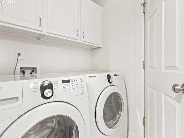 clothes washing area with cabinets and independent washer and dryer