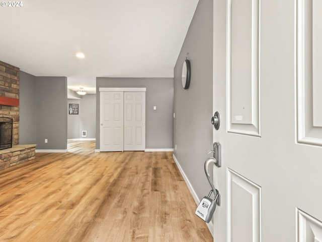 living room with a fireplace and light hardwood / wood-style flooring