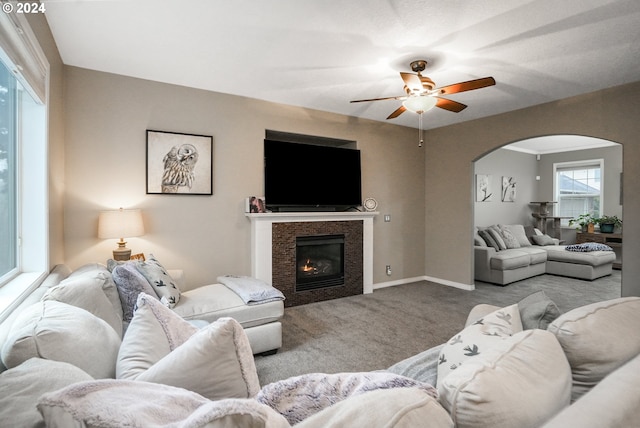 living room with ceiling fan and light colored carpet