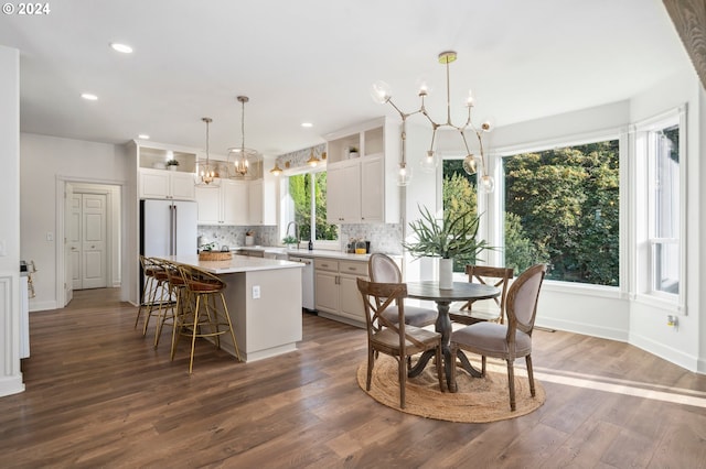 kitchen featuring plenty of natural light, a kitchen island, and white cabinets