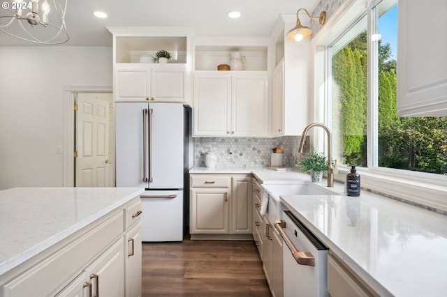 kitchen featuring dark hardwood / wood-style floors, an inviting chandelier, dishwasher, high end white fridge, and white cabinets