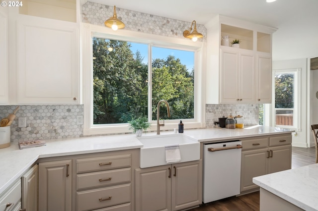 kitchen featuring backsplash, dishwasher, dark hardwood / wood-style flooring, sink, and gray cabinetry