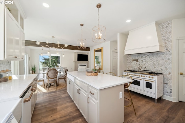 kitchen with dark wood-type flooring, premium range hood, white appliances, and white cabinets