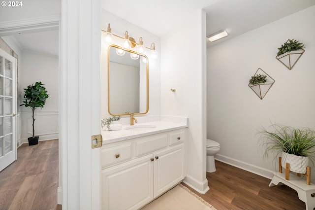 bathroom featuring vanity, toilet, and hardwood / wood-style flooring