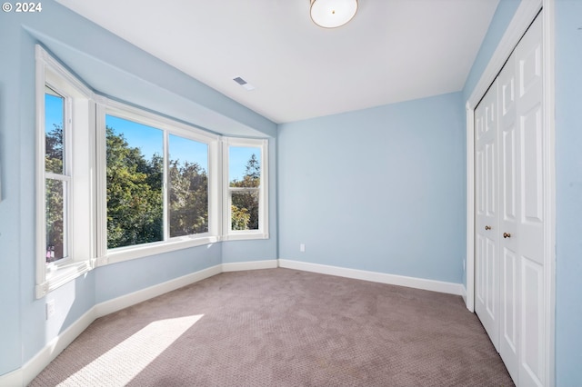 unfurnished bedroom with a closet and carpet flooring