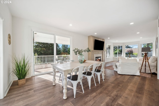 dining room with a fireplace and wood-type flooring