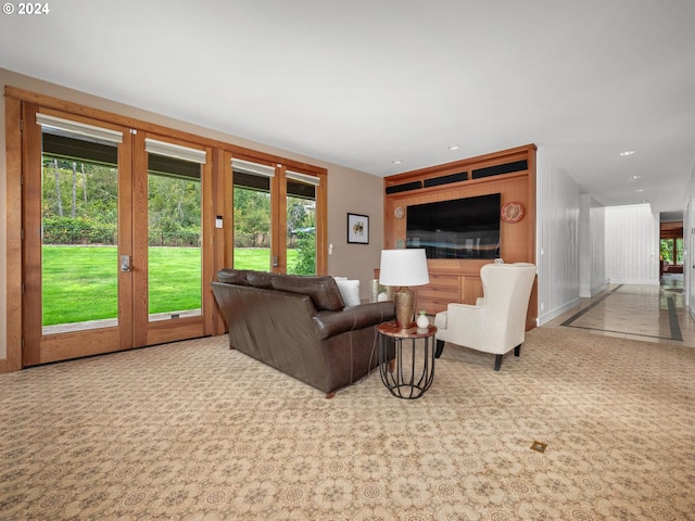 living room featuring light carpet, french doors, and a healthy amount of sunlight