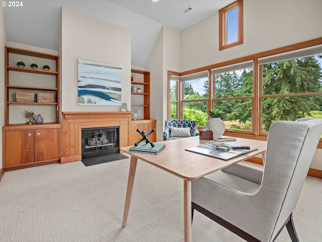 carpeted dining area with high vaulted ceiling