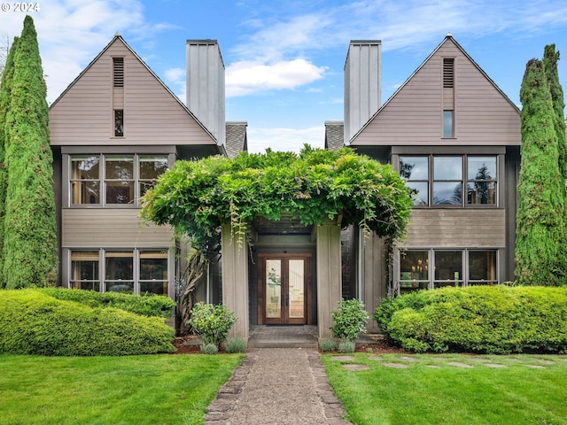 view of front facade with french doors and a front yard