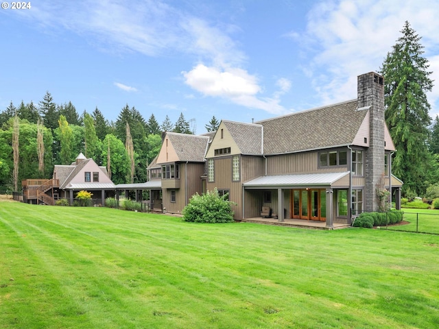 rear view of house featuring a lawn