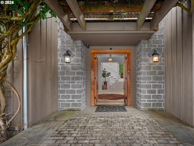 doorway to property with brick siding