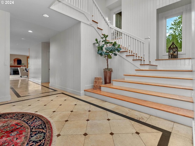 stairway with recessed lighting, baseboards, and tile patterned floors