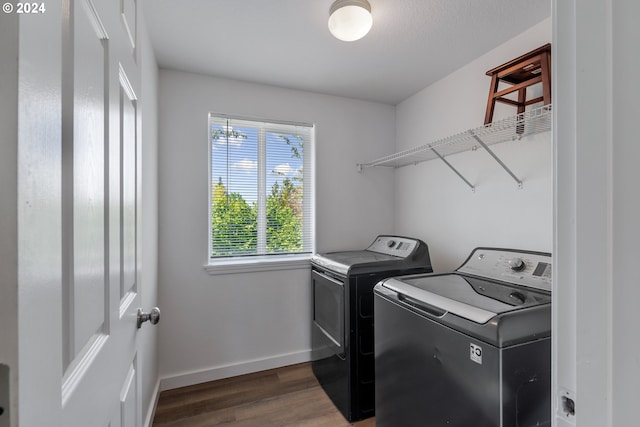 laundry room with dark hardwood / wood-style floors and independent washer and dryer