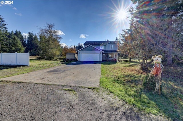 view of front of house featuring a front lawn and a garage