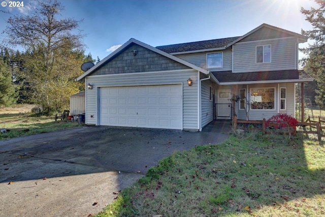 view of front of property featuring covered porch and a garage