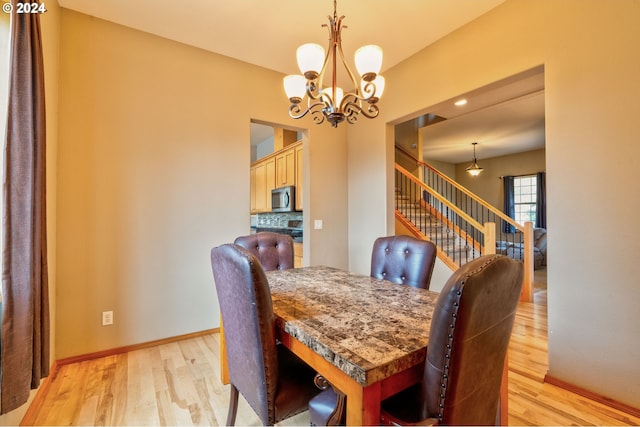 dining area featuring an inviting chandelier and light wood-type flooring