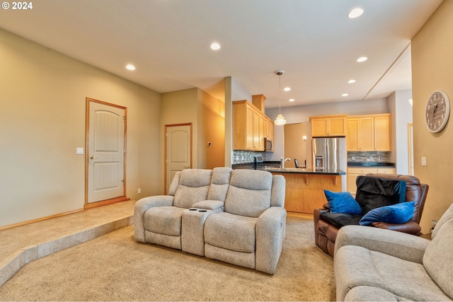 living room with sink and light colored carpet