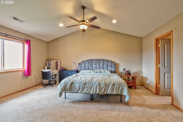 bedroom with ceiling fan, light colored carpet, and vaulted ceiling