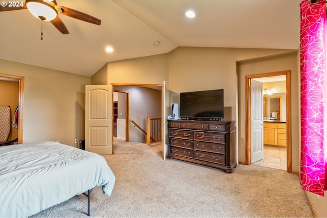 carpeted bedroom featuring ensuite bathroom, ceiling fan, and vaulted ceiling