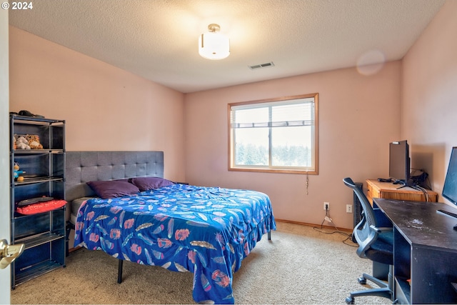 bedroom featuring carpet and a textured ceiling