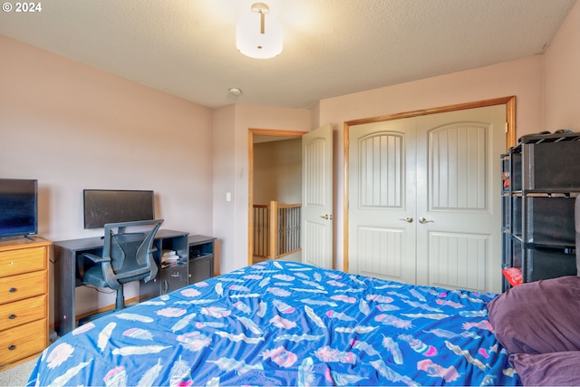 bedroom with a closet and a textured ceiling