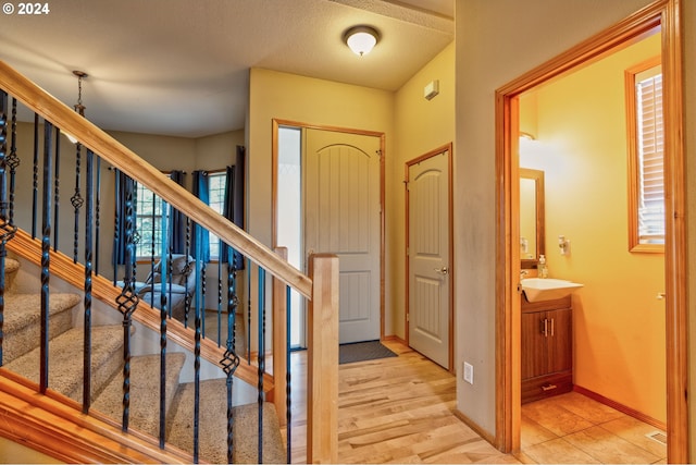 foyer featuring a textured ceiling and light hardwood / wood-style floors