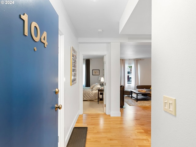 corridor with light hardwood / wood-style floors