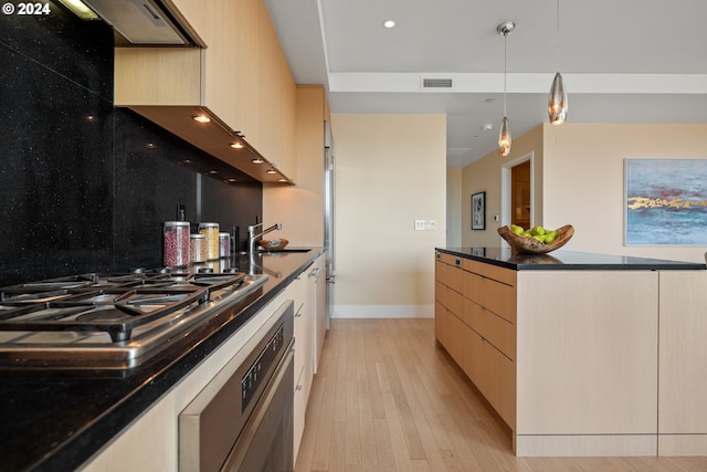 kitchen with light hardwood / wood-style flooring, light brown cabinetry, stainless steel appliances, and pendant lighting