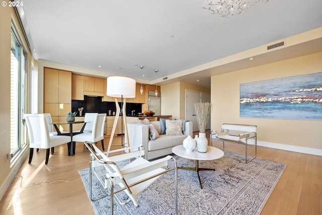 living room featuring light hardwood / wood-style flooring and a healthy amount of sunlight