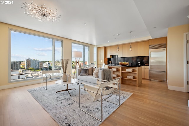 living room featuring a chandelier and light hardwood / wood-style flooring