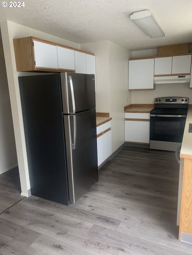 kitchen with stainless steel appliances, light wood-type flooring, and white cabinetry