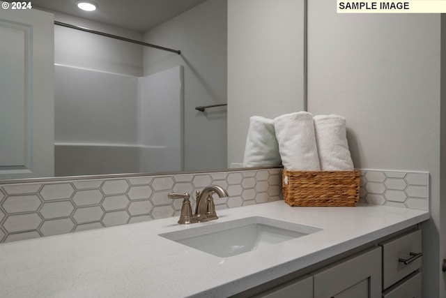 bathroom featuring tasteful backsplash and vanity