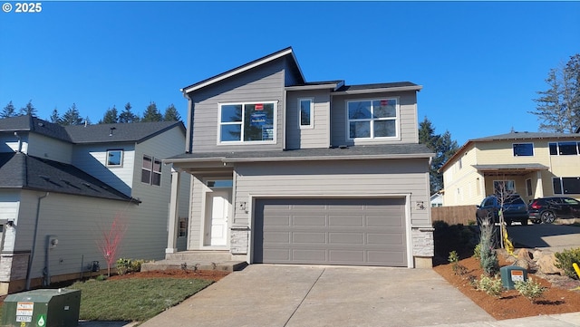 view of front of property featuring a garage, concrete driveway, and fence