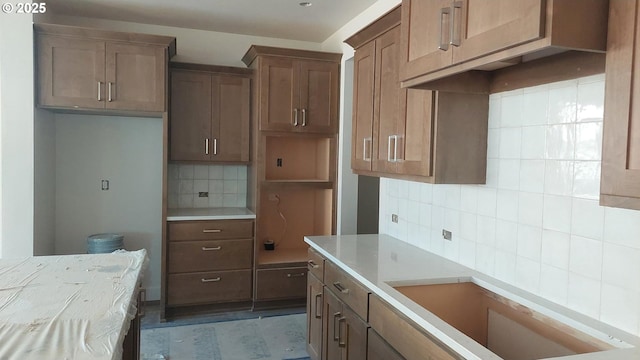 kitchen with decorative backsplash and light countertops