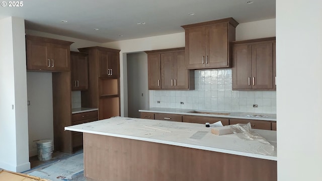 kitchen with stovetop and decorative backsplash