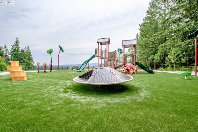 community jungle gym featuring a lawn