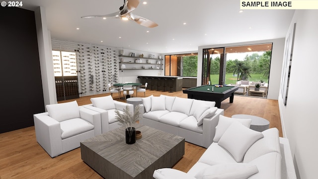 living room with bar area, light hardwood / wood-style flooring, and billiards