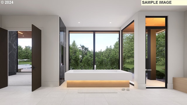 bathroom with tile patterned floors, a tub, and a wealth of natural light