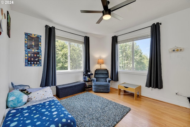 bedroom with hardwood / wood-style floors and ceiling fan