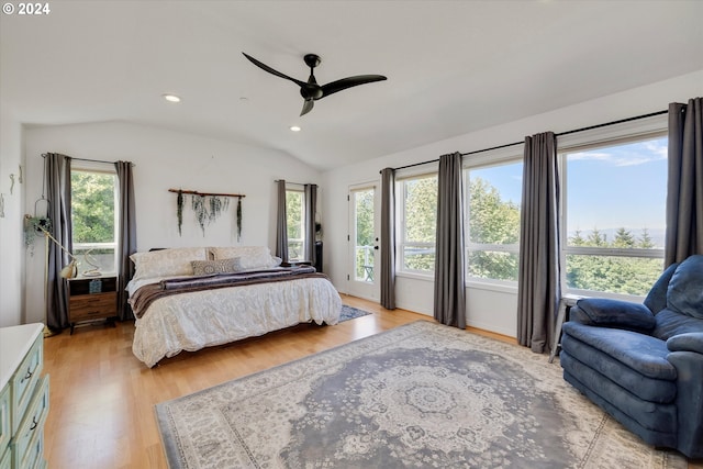 bedroom featuring vaulted ceiling, multiple windows, and light hardwood / wood-style flooring