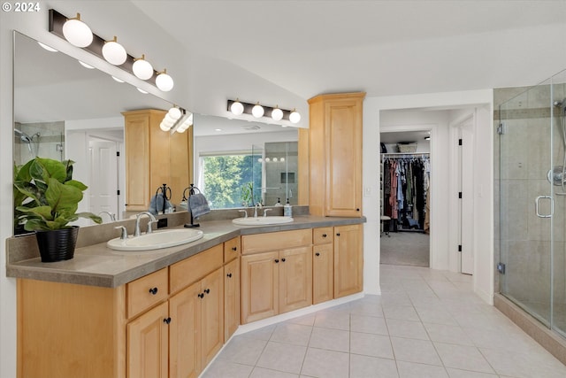 bathroom with tile patterned floors, a shower with shower door, vaulted ceiling, and vanity