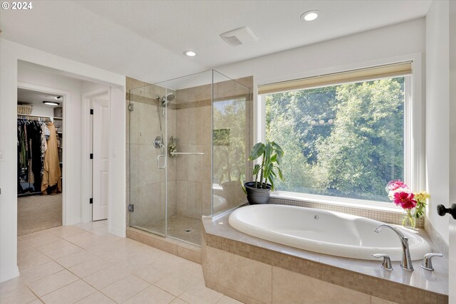 bathroom with independent shower and bath and tile patterned floors