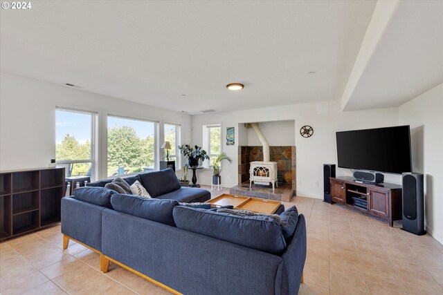 tiled living room featuring a wood stove