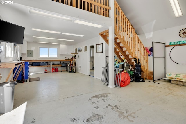 garage featuring electric panel and a workshop area