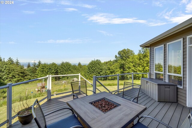 wooden deck with a fire pit